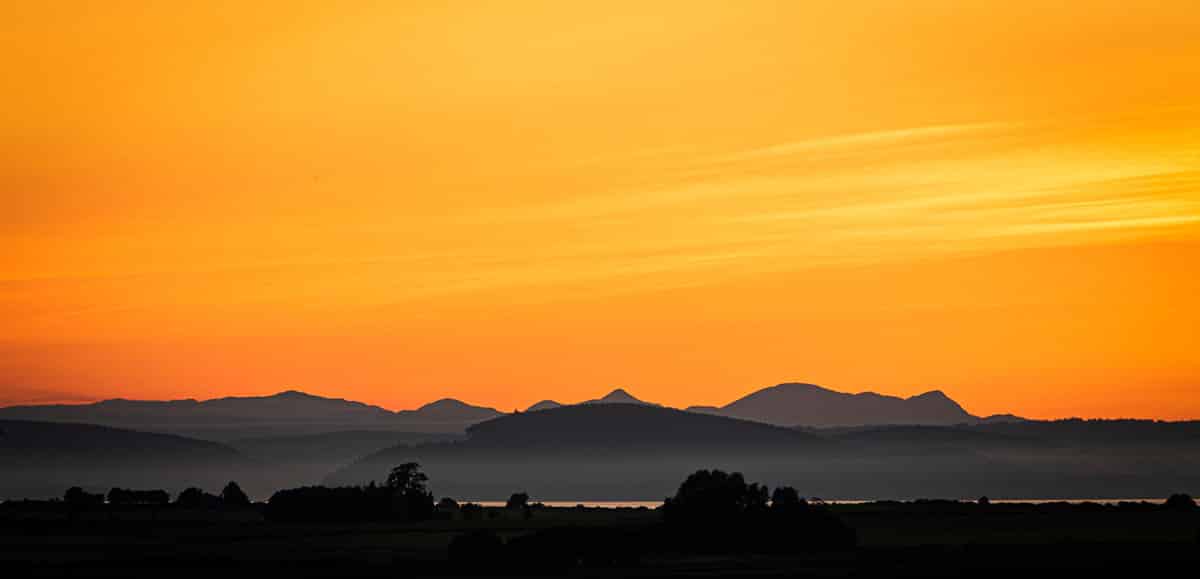 Sunset over the Moray Firth to the Black Isle and then the peaks of Ben Wyvis beyond - things to do near Nairn