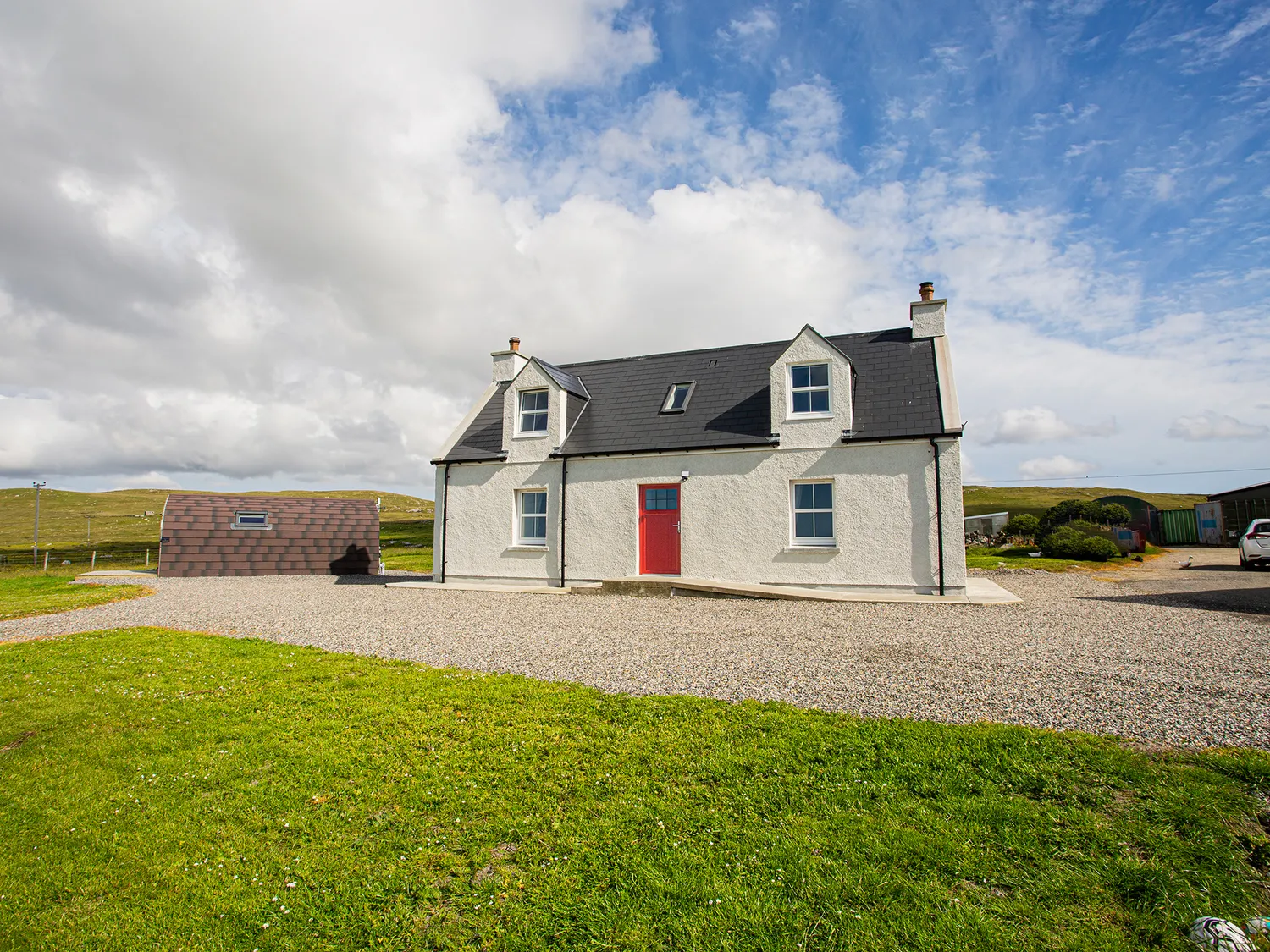 two-storey traditional Hebridean croft house with red door 3 Sollas