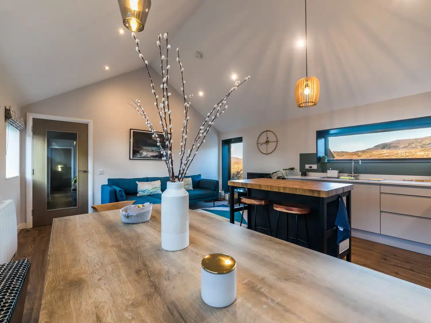 living space in modern home with view of hills through windows