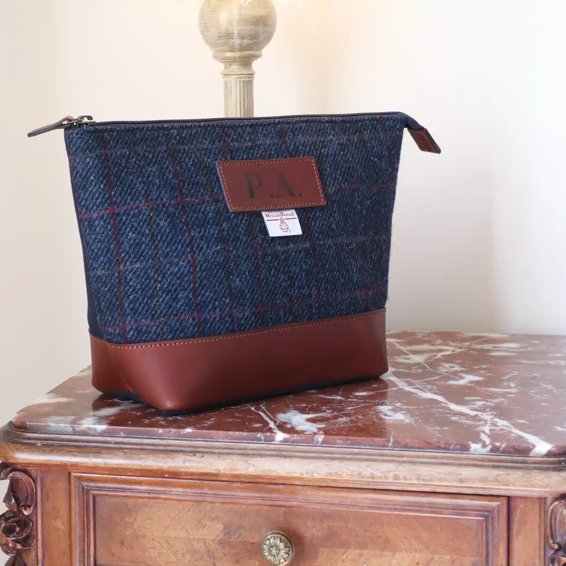 Harris tweed washbag in navy tweed with leather bottom and monogrammed