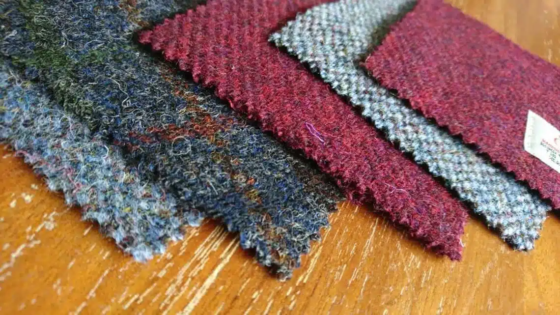 Harris Tweed coasters in red and grey on wooden background