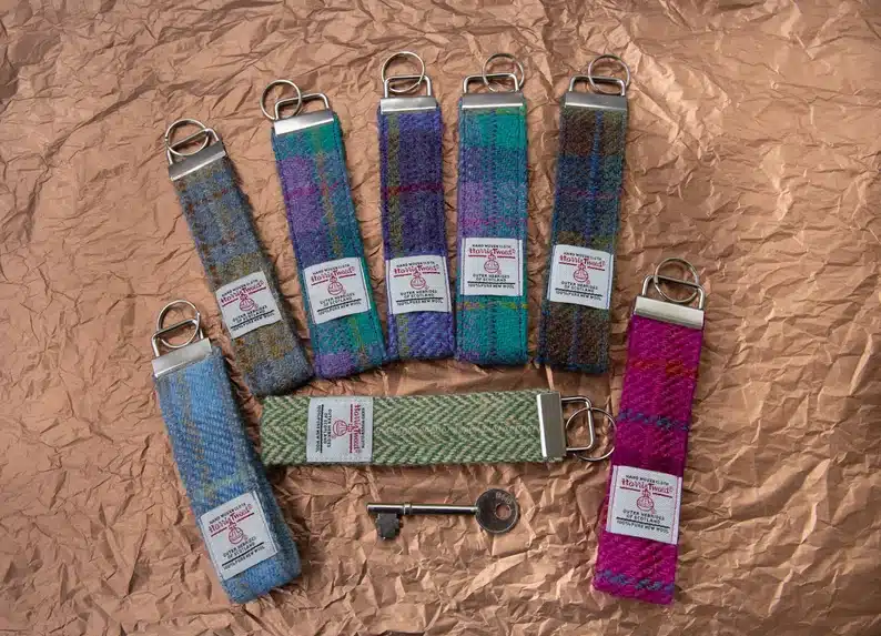 Harris Tweed key rings in different colours on brown background