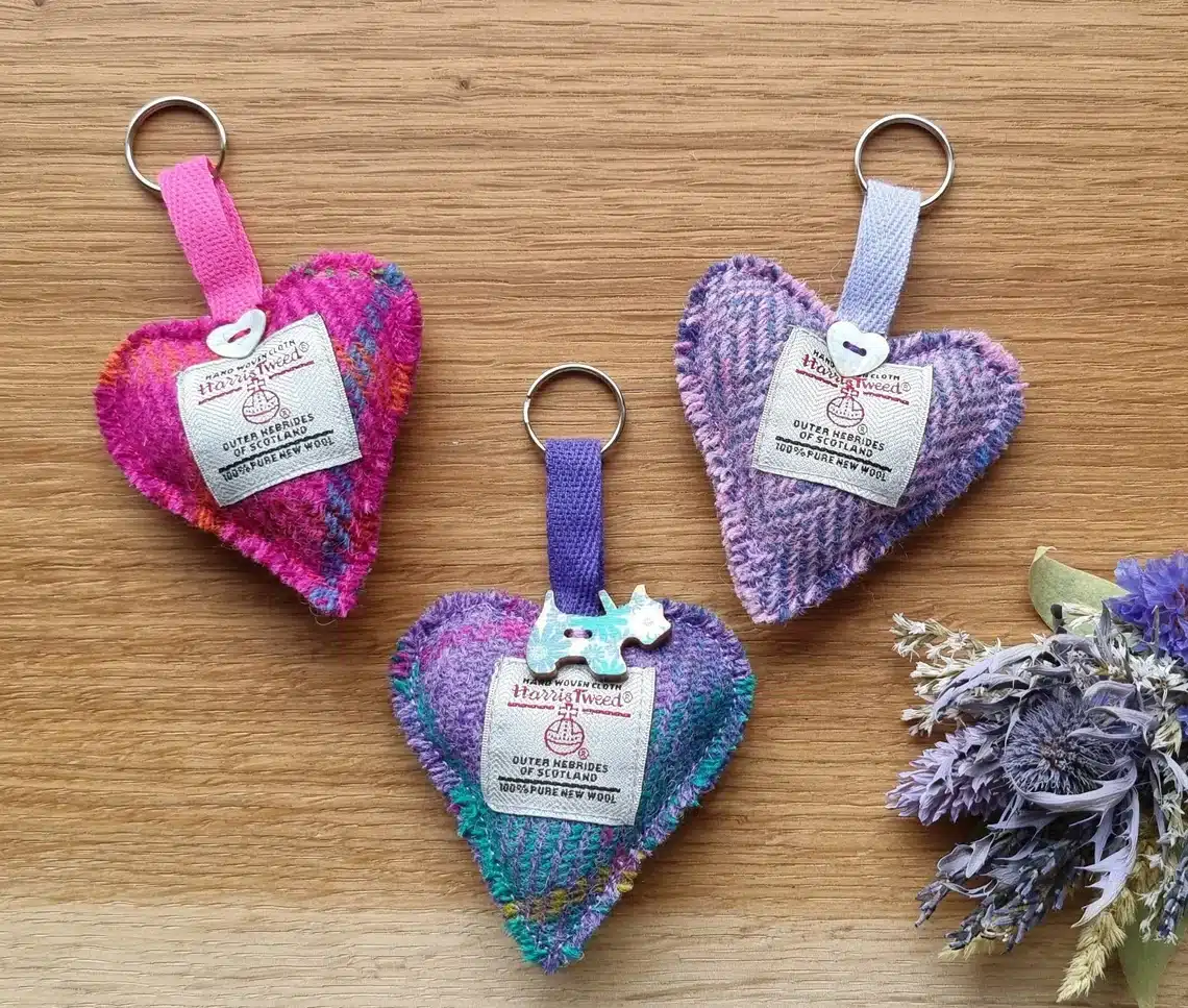 Harris tweed heart-shaped key rings on wooden background