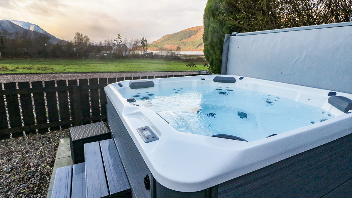 Island View House hot tub in garden with hills in distance