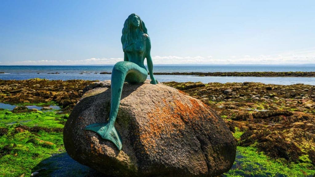 Mermaid of the north statue sat on the rock