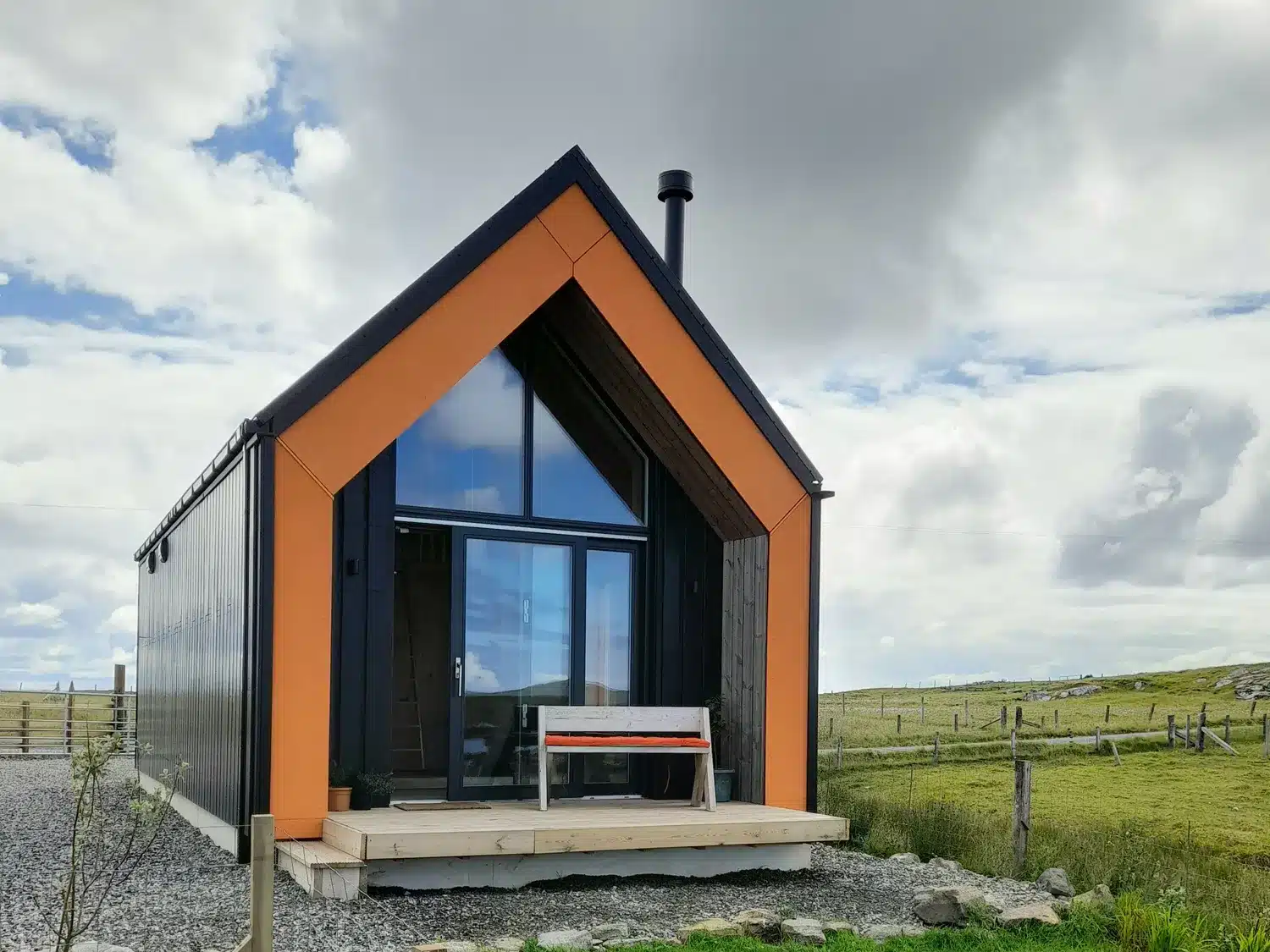 Scandinavian style orange studio home in a field - North Light Studi Locheport