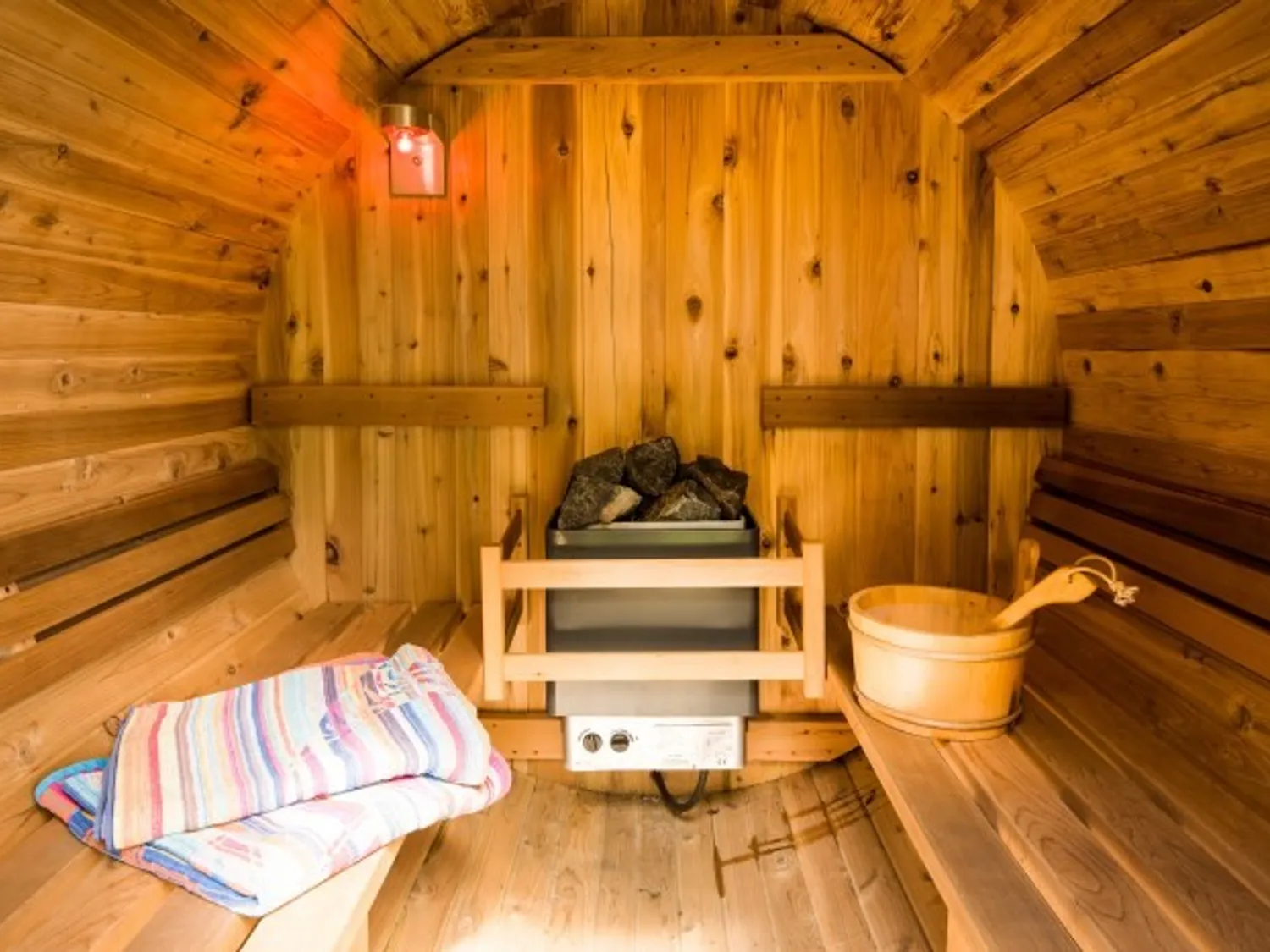 Strone House inside of barrel sauna with towels on bench